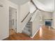 Carpeted stairs lead to a bright living area with a fireplace at 4829 Baldwin Pl, Boulder, CO 80301