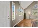Bright foyer featuring hardwood floors, vaulted ceilings, and large windows at 4829 Baldwin Pl, Boulder, CO 80301