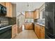 Bright kitchen with wooden cabinets, modern appliances and view into the living room at 4829 Baldwin Pl, Boulder, CO 80301