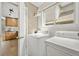 Bright laundry room featuring a washer and dryer, natural light, and shelf storage at 4829 Baldwin Pl, Boulder, CO 80301