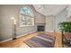 Cozy living room with fireplace, hardwood floors, and large windows at 4829 Baldwin Pl, Boulder, CO 80301