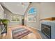 Bright living room with vaulted ceiling, large windows, fireplace and wood-look floors at 4829 Baldwin Pl, Boulder, CO 80301