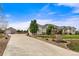 Long driveway leads to a spacious house with a three-car garage at 17155 Primrose Ln, Mead, CO 80542