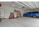 Spacious garage with storage, refrigerator, and a parked blue truck at 17155 Primrose Ln, Mead, CO 80542