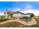 Single story home with garden and covered patio with stone fireplace at 17155 Primrose Ln, Mead, CO 80542