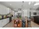 Modern kitchen featuring a large island with a wine cooler and white cabinets at 17155 Primrose Ln, Mead, CO 80542
