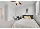 Bedroom featuring carpet, ceiling fan, desk, and comfortable bed with decorative pillows at 8977 E Otero Pl, Centennial, CO 80112