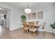 Elegant dining room boasts a wood table, stylish chairs, and eye-catching chandelier at 8977 E Otero Pl, Centennial, CO 80112