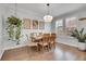 Bright dining room featuring a wood table, stylish light fixture, and light hardwood floors at 8977 E Otero Pl, Centennial, CO 80112