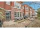Charming red brick townhome with a cozy outdoor patio and seating area at 8977 E Otero Pl, Centennial, CO 80112
