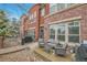 Charming red brick townhome with a cozy outdoor patio and seating area at 8977 E Otero Pl, Centennial, CO 80112