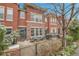 Charming red brick townhome with a cozy outdoor patio and seating area at 8977 E Otero Pl, Centennial, CO 80112