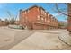 Exterior view of the townhome featuring garages and lush surroundings at 8977 E Otero Pl, Centennial, CO 80112