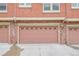 Individual garage with brick trim, carriage doors, and space for parking at 8977 E Otero Pl, Centennial, CO 80112