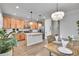 Open-concept kitchen with wood cabinets, granite countertops, and stainless steel appliances at 8977 E Otero Pl, Centennial, CO 80112