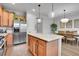 Open-concept kitchen boasts a center island, wood cabinets, and stainless steel appliances at 8977 E Otero Pl, Centennial, CO 80112