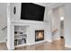 Living room with a fireplace, built-in shelving, and stylish hardwood floors at 8977 E Otero Pl, Centennial, CO 80112