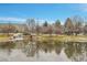 Scenic view of the community pond with a waterfall and surrounding greenery with buildings in the background at 8977 E Otero Pl, Centennial, CO 80112