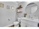 Stylish powder room with modern fixtures, floating shelves, and white quartz countertops at 8977 E Otero Pl, Centennial, CO 80112