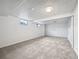 View of the finished basement showcasing the neutral carpet, white walls, and a small window at 10371 Monterey Cir, Northglenn, CO 80260
