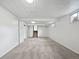 View of the finished basement showcasing the neutral carpet, white walls, and access to the staircase at 10371 Monterey Cir, Northglenn, CO 80260