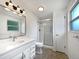 Clean bathroom featuring a vanity with modern fixtures, a shower with glass door, and neutral color tones at 10371 Monterey Cir, Northglenn, CO 80260