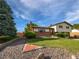 Charming home with mature landscaping, and brick accents create an inviting curb appeal, and stone landscaping accents at 10371 Monterey Cir, Northglenn, CO 80260