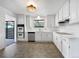 Bright kitchen with white cabinets, stainless steel appliances, and modern lighting creating a clean cooking space at 10371 Monterey Cir, Northglenn, CO 80260