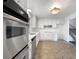 Bright kitchen features stainless steel appliances, white cabinets, and ample counter space at 10371 Monterey Cir, Northglenn, CO 80260