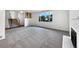 Spacious living room features neutral carpet, fireplace, and bright window with neighborhood views at 10371 Monterey Cir, Northglenn, CO 80260