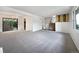 Open living room boasts plush carpeting, natural light, and seamless flow to the dining area at 10371 Monterey Cir, Northglenn, CO 80260