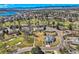 A stunning aerial view captures a scenic neighborhood with lush greenery, a golf course, a lake, and tree-lined streets at 13 Wedge Way, Littleton, CO 80123