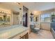 Classic bathroom with dual sinks, a vanity area, and a separate toilet room at 13 Wedge Way, Littleton, CO 80123