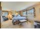 Comfortable bedroom featuring large windows and a cozy seating area at 13 Wedge Way, Littleton, CO 80123