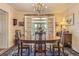 Elegant dining room with a chandelier, a wooden table, and a view to an enclosed patio at 13 Wedge Way, Littleton, CO 80123