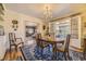Elegant dining room featuring hardwood floors, a chandelier, and access to a sunroom at 13 Wedge Way, Littleton, CO 80123