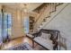 Inviting foyer with hardwood floors, a staircase, and a bench near the front door and window at 13 Wedge Way, Littleton, CO 80123