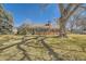 Charming brick home with a mature tree in the front yard and a pathway leading to the front door at 13 Wedge Way, Littleton, CO 80123