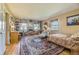 Cozy living room with a brick fireplace, built-in shelves, and ample natural light at 13 Wedge Way, Littleton, CO 80123