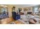 Cozy living room featuring hardwood floors, a fireplace, built-in shelves, and comfortable seating at 13 Wedge Way, Littleton, CO 80123