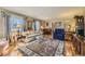 Cozy living room with hardwood floors, a plush sofa, large windows, and elegant decor at 13 Wedge Way, Littleton, CO 80123