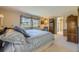 Spacious primary bedroom with large windows, a dresser, and an ensuite bathroom at 13 Wedge Way, Littleton, CO 80123