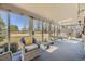 Bright sunroom with panoramic views of the landscaped backyard at 13 Wedge Way, Littleton, CO 80123