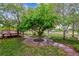 Lush backyard features mature trees, green grass, and a charming gazebo, creating a peaceful outdoor oasis at 6519 Eastview St, Longmont, CO 80504