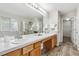 Bright bathroom features double sinks, and a glass enclosed shower for a luxurious experience at 6519 Eastview St, Longmont, CO 80504
