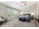 Cozy bedroom with a large window, neutral colors, soft carpet and modern furniture at 6519 Eastview St, Longmont, CO 80504