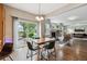 Bright dining area with hardwood floors, sliding glass doors to a deck, and adjacent living space at 6519 Eastview St, Longmont, CO 80504