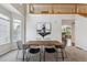 Dining room with tall ceilings, a modern table, and abundant natural light at 6519 Eastview St, Longmont, CO 80504