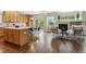 Open-concept kitchen, dining area and living room with hardwood floors and natural light at 6519 Eastview St, Longmont, CO 80504