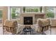 Living room featuring a fireplace, cozy seating, and bright natural light at 6519 Eastview St, Longmont, CO 80504